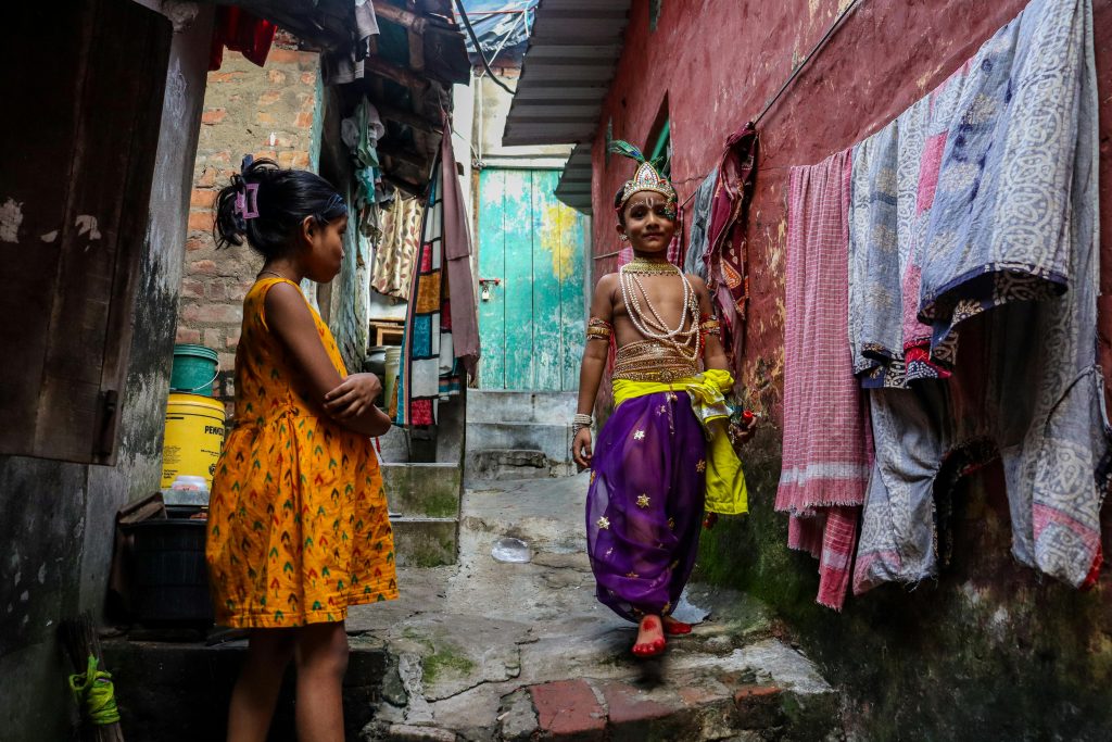 street photography of kids in colourful attire in a Kolkotta backstreet.